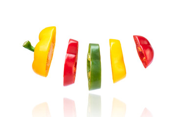 Sliced yellow red and green bell pepper  isolated on white background