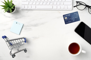 Top view of online shopping concept with credit card, smart phone and computer.