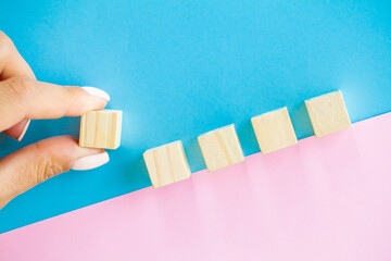 Woman hand putting and stacking blank wooden cubes on desk with copy space for input wording and...