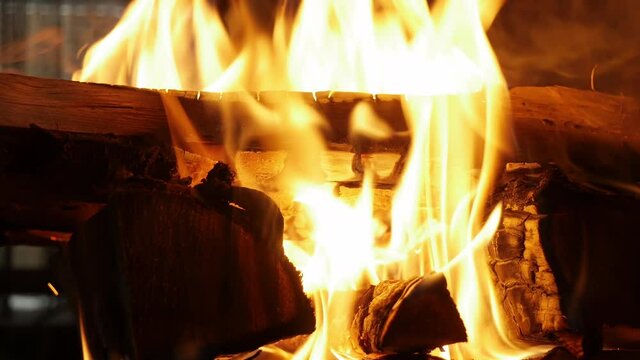  lose up view of fireplace bonfire indoors, forks of flame of fire in country house. Cozy weekend, firewood, burning logs, romantic evening. Warmth, resting, home comfort concept. low light