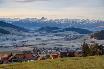 overlooking the village of Möschberg, Grosshöchstetten and Konolfingen at sunrise with hills of Emmental and Bernese Alps
