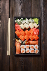set of sushi and rolls seafood wooden table chopsticks wasabi