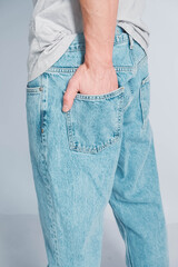 Back pocket of blue jeans. Man's hand in the back pocket of jeans. Copy, empty space for text