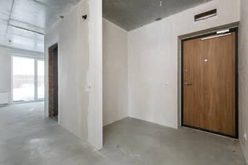 Obraz premium interior of the apartment without decoration in gray colors. rough finish