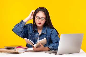 Young student study at home, learning lesson online Student girl get confused University student woman listen lecture and read text book while teacher teaching on video conference Distant education 
