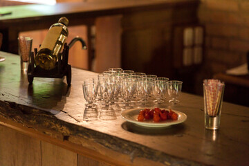 Glasses of (cachaça) in a (cahcaçaria) tasting with a rustic climate, woody counter and drinks being prepared. Cachaça concept. Drink concept.
