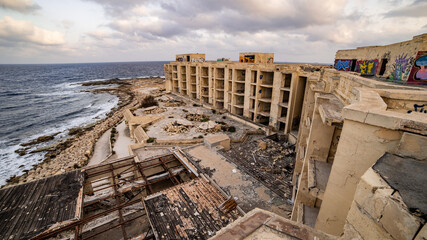 Old abandoned hotel on the beach in Malta Wara l-Jerma Bay