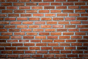Brick wall, brick texture surface, red brick pattern background with dark vignetted corners.