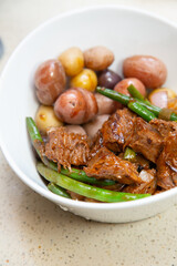 Tri-tip steak, green beans strings, onions in a cast iron cooking wok