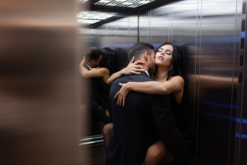 Young sexy couple making love in elevator