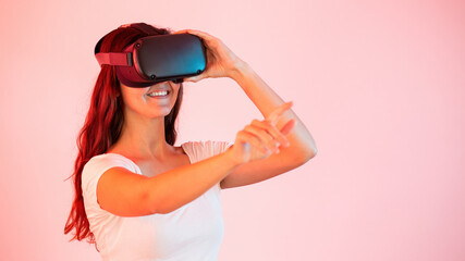 Woman in virtual reality stretching her hand and touching something with finger. Concept of modern digital wearable device changing perception of surrounding environment.