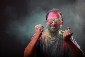 Man plays with Holi festival colours.Concept for Indian festival Holi