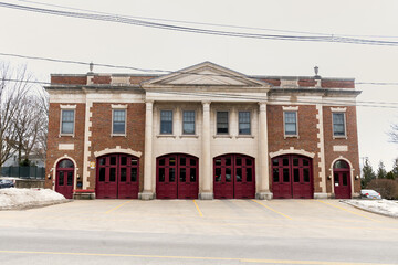 Fototapeta na wymiar Saratoga Springs, NY - USA - Mar. 6, 2021: Landscape view of the historic Saratoga Springs Fire Department Station 1 at 60 Lake Ave.