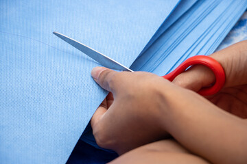 The cutting sterilization wrapping paper, close up. A homemade produce of masks to protect against...