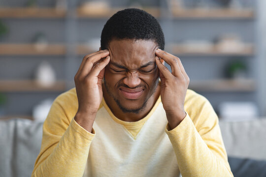 Closeup of african american man suffering from headache