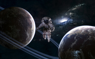 Astronaut in outer space. Planets on background of galaxy. Science fiction. Elements of this image...