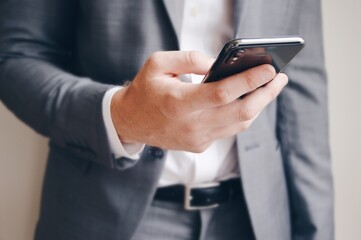 Midsection of a businessman using his mobile phone