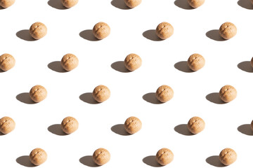 Walnuts on a white background. A pattern of walnuts on a white background.
