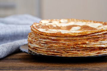 A tall stack of pancakes. Breakfast for the whole family. Maslenitsa, the holiday of the end of...