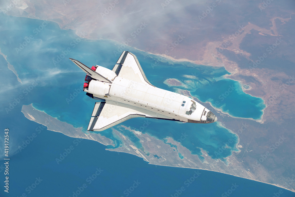 Poster spacecraft shuttle flies over the beautiful overhead view of the planet earth with the sea and islan