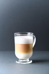 Coffee with milk on gray background. Close up. Copy space. 
