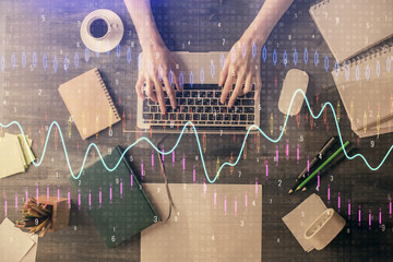 Multi exposure of woman hands working on computer and forex chart hologram drawing. Top View. Financial analysis concept.