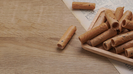 Thong Muan , Thai dessert, as a snack , On a wooden plate, made from flour, coconut milk, and eggs, in an atmosphere, vintage style.