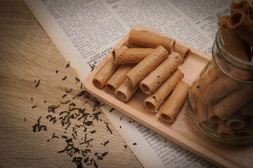 Thong Muan , Thai dessert, as a snack , On a wooden plate, made from flour, coconut milk, and eggs, in an atmosphere, vintage style.