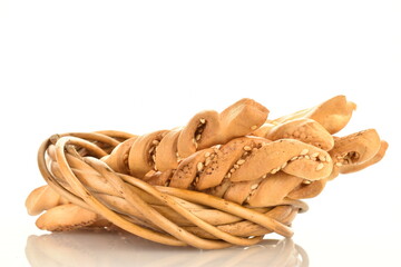 Several delicious grissini bread sticks with a vine wreath, close-up, isolated on white.