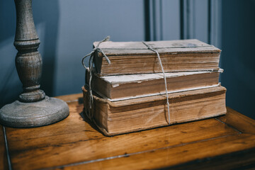 There is an old stack of books on the shelf