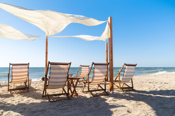 Beautiful summer beach background, scene with chairs, blue sea and sand