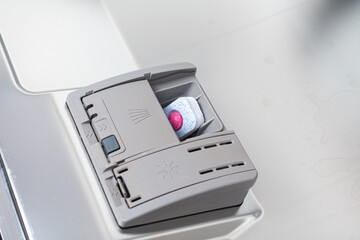 Soap tablet of a detergent for washing dishes in dishwashing machine. 