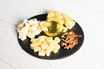 Nuts, cheese and honey on plate. Cheese plate