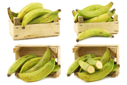 unripe baking bananas (plantain bananas) and a cut one  in a wooden crate on a white background