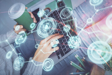 Double exposure of woman hands typing on computer and social network theme hologram drawing. People media concept.