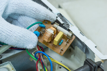 Technician repair microwave oven mainboard, Checking microwave oven mainboard, Home appliances repair service.
