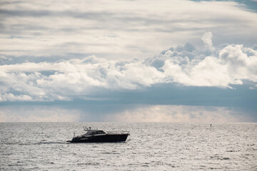 boat sailing in the sea under similar clouds