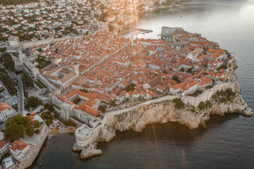 Aerial drone shot of Dubronik city wall by Adriatic sea in Croatia summer sunrise