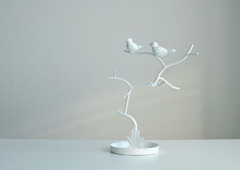 Decorative birds for decoration in the interior, stand for jewelry on a white background