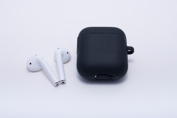Bluetooth wireless earphone with charging case on white background