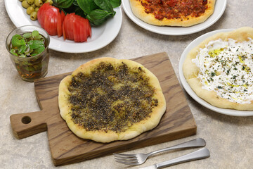 manakeesh, lebantine pizza, topping with zaatar(thyme), labneh(strained yogurt) and groud beef
