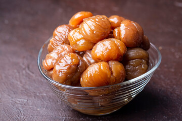 Chestnut dessert and chestnuts on a plate. Traditional delicious Turkish dessert; chestnut candies (Kestane Sekeri)