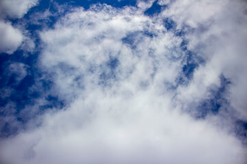 White fluffy clouds on a background of blue sky.