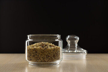 Rice in a glass jar. Black background.