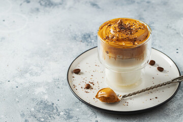 Dalgona coffee. Iced fluffy creamy whipped trend drink with coffee foam and milk. Trendy drink during Covid-19 city lock down and self quarantine, stay at home concept. With copy space