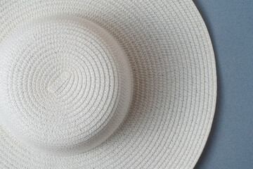 A large white beach lady's hat on a pastel beige background. The concept of vacation, vacation, travel, sales, black Friday.