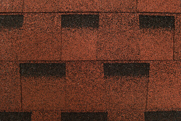 Fototapeta na wymiar brown, grainy background of bituminous roofing tiles, top view