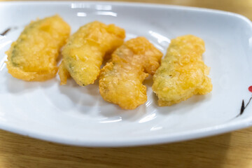 crispy fried zucchini on a white plate
