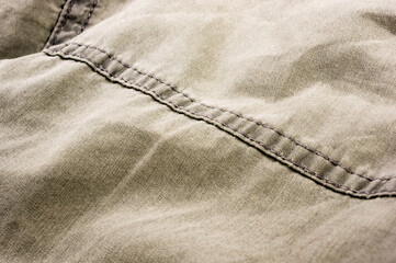 clothing items stonewashed cotton fabric texture with seams, clasps, buttons and rivets, macro