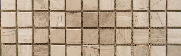 background of small, beige marble tiles, top view, banner